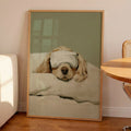Minimalist oil painting print of a white cocker spaniel tucked up in bed wearing a silk eye mask, painted in soft cream tones against a sage green background