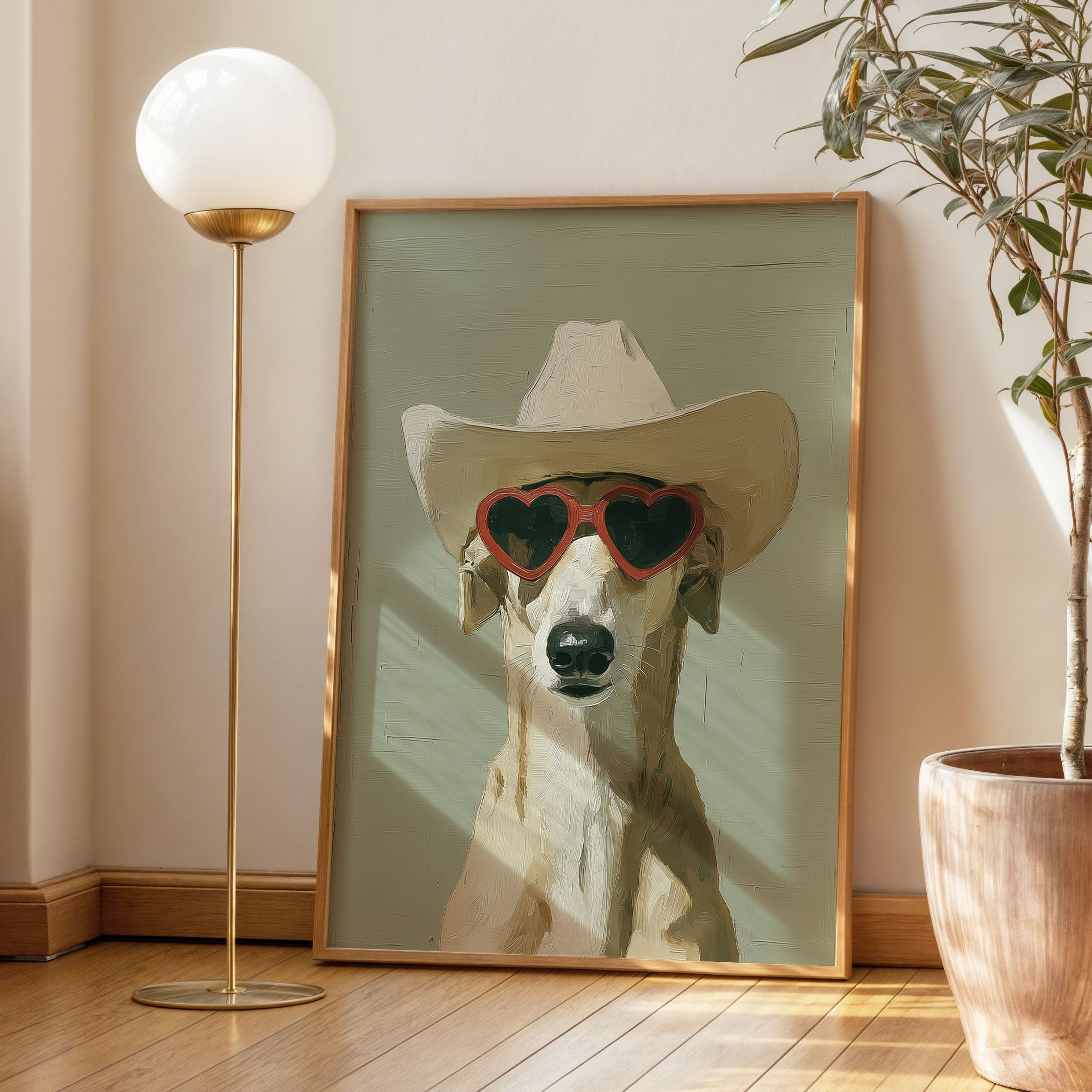 Minimalist oil painting print of a fawn greyhound wearing an oversized cowboy hat and red heart shaped sunglasses, painted in warm sandy tones against a soft sage green background